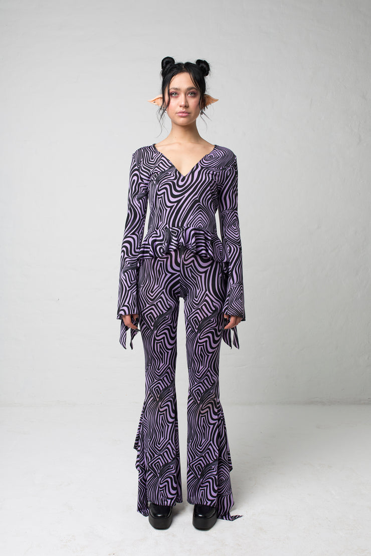 fashion brand BONDY showcasing handmade SERAPHINA purple and black abstract high waisted side slit flare pants/trousers shown on a size small model, part of the new DREY:MA collection. full body front view