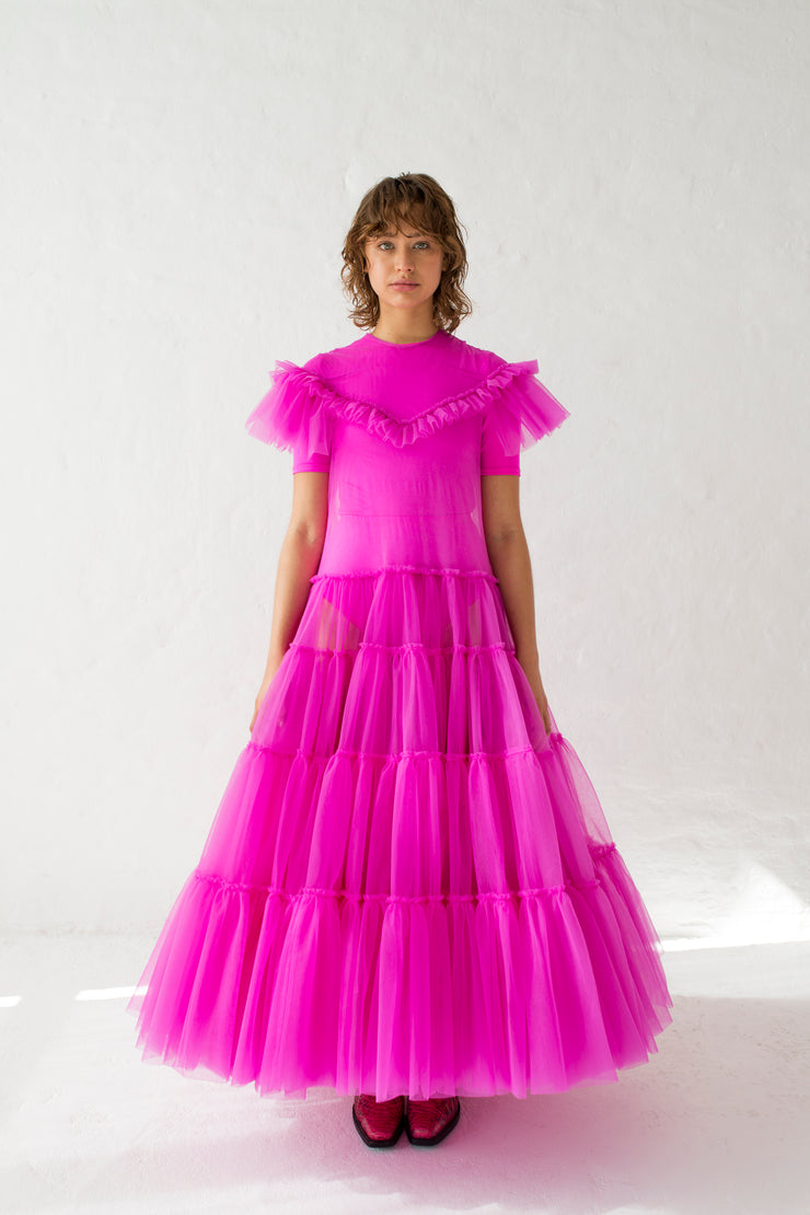 A tulle dress in fuchsia wit  layered ruffles, short sleeve and round neckline