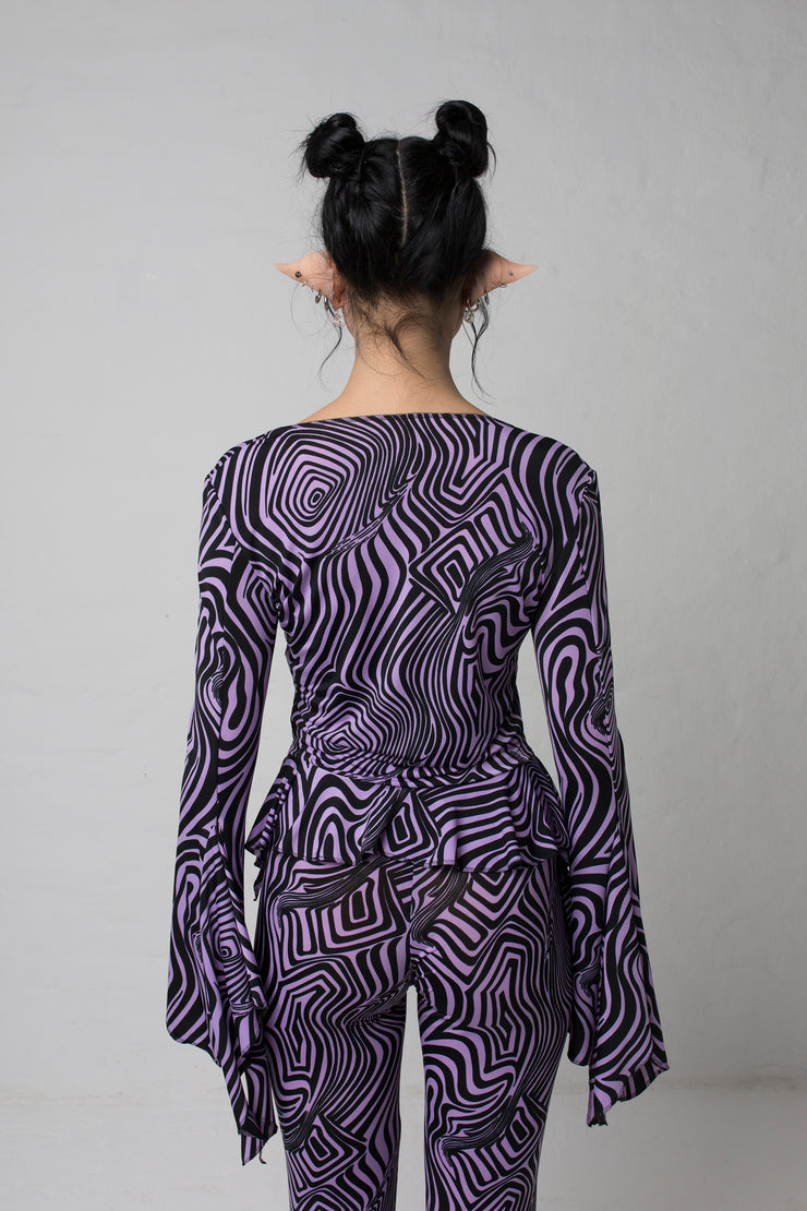 fashion brand BONDY photoshoot showcasing handmade AURORA abstract long-sleeve purple and black flare top on size small model, part of new collection DREY:MA. back view