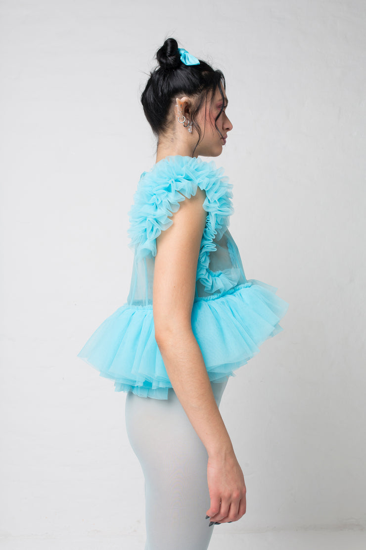 fashion brand BONDY photoshoot showcasing handmade FLEUR ice blue cropped, sheer ruffle 100% tulle top shown on a size small, part of the new collection DREY:MA. side view