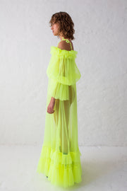 Flue yellow floor length evening gown with voluminous off-shoulder puffy sleeves and thin shoulder straps. Contrasted by sheer body and ruffled hem