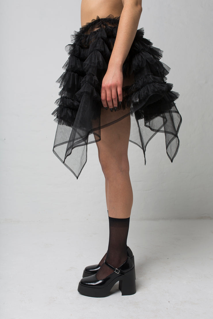 fashion brand BONDY showcasing handmade NERA high waisted double layered black tulle mini skirt with ruffle detail shown on size small model, part of the new collection DREY:MA. side view