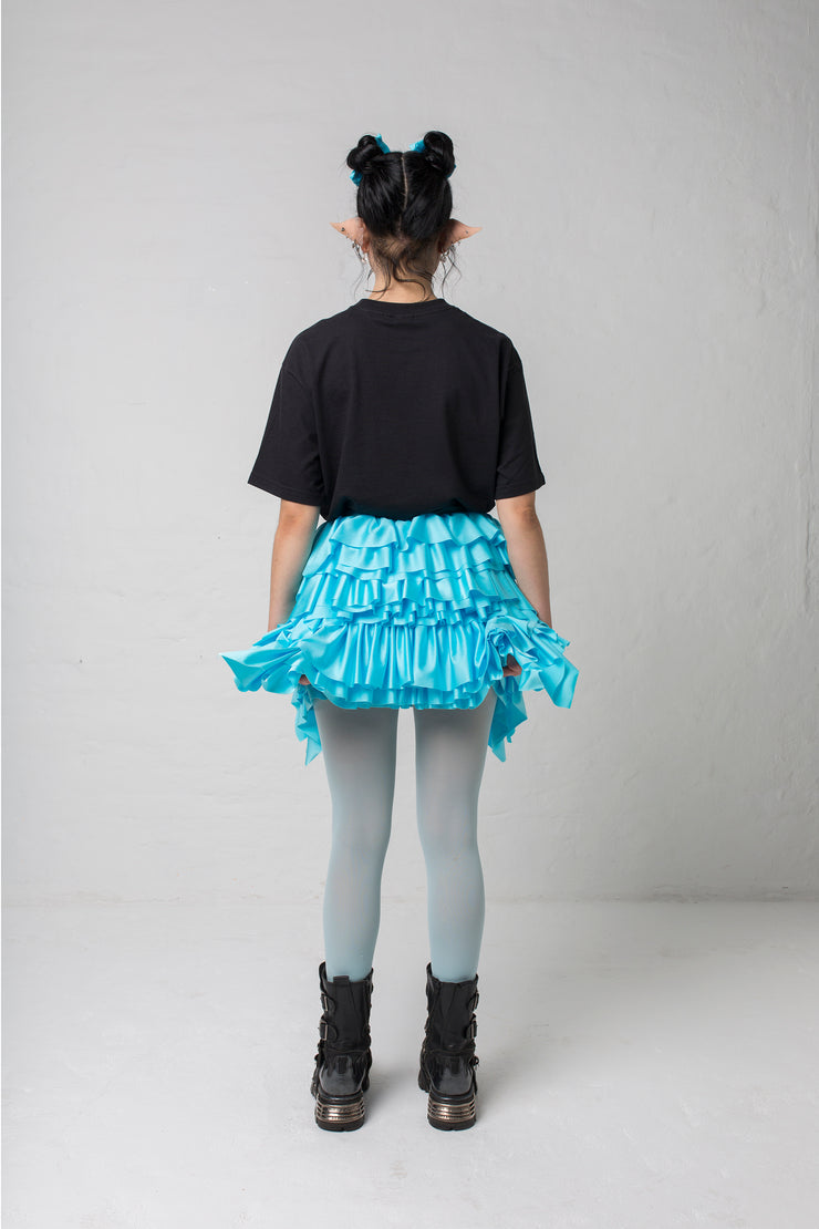 fashion brand BONDY photoshoot showcasing handmade CASSIA mini ruffle ice blue skirt shown on size small model, part of new collection DREY:MA. full body back view