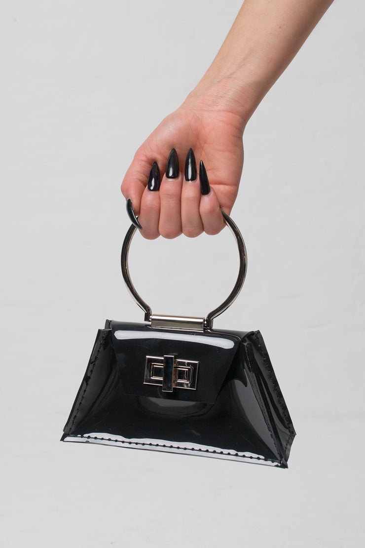 fashion brand BONDY showcasing handmade ZELDA black 100% PVC bag with big ring as handle, part of the new collection DREY:MA. front view