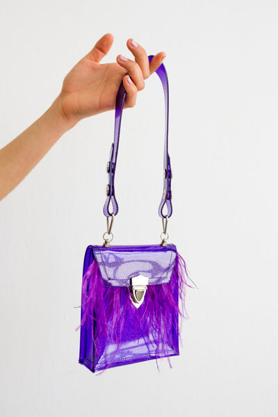Purple glitter PVC mini bag with ostrich feather trim and contrasting hardwarrePurple glitter PVC mini bag with ostrich feather trim and contrasting hardware